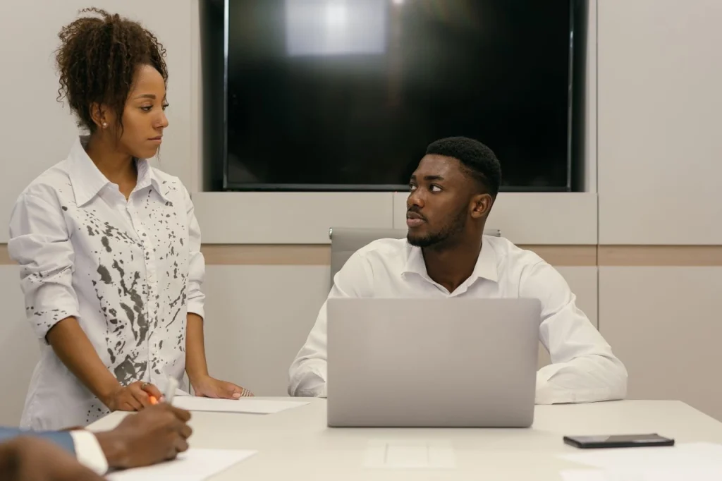 Colleagues talking business in an office. Small Business Grants for Kenyan entrepreneurs